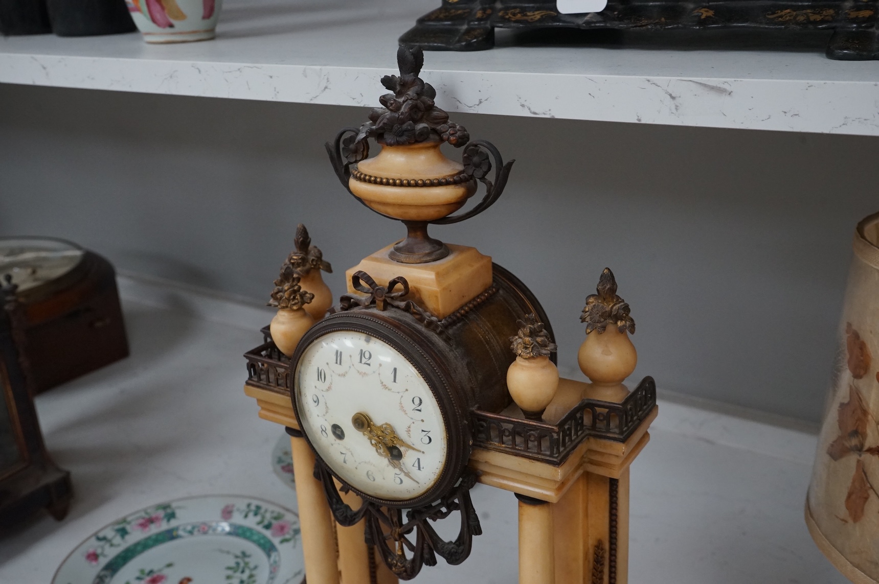 A French gilt metal and alabaster mantel clock, striking on a bell, with pendulum, 49cm high